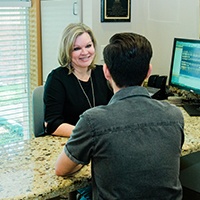 Patient checking in at reception desk