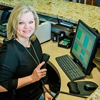 Dental team member at reception desk