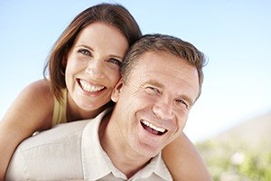 Smiling man and woman outdoors