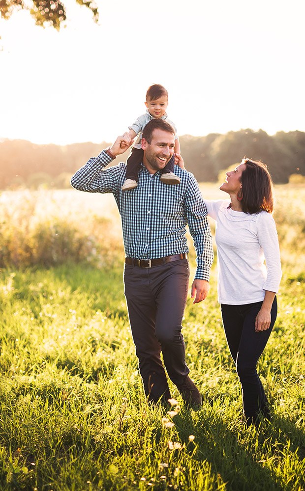 Smiling mother father and child outdoors