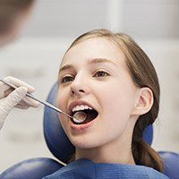 Young girl in dental exam chair
